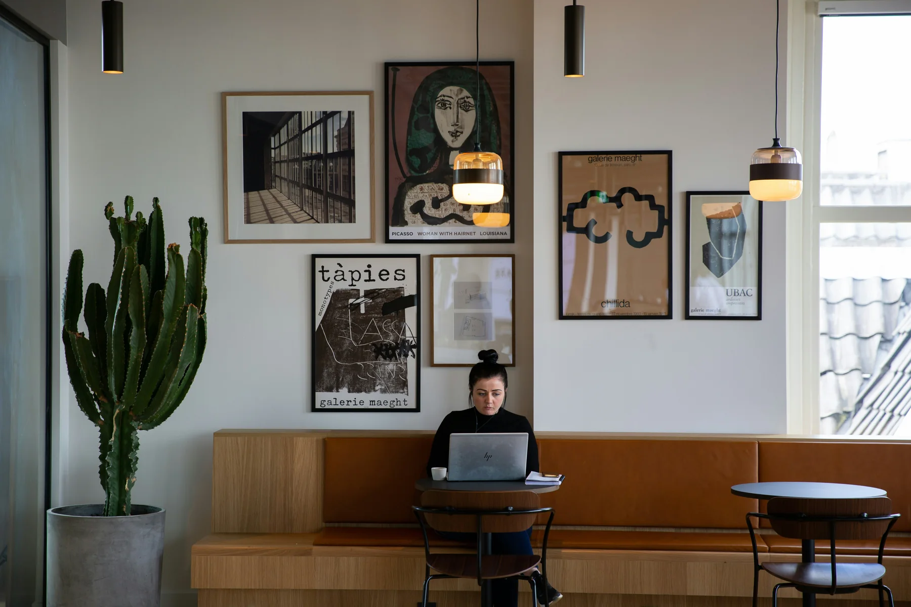 A professional working on a laptop in a quiet café