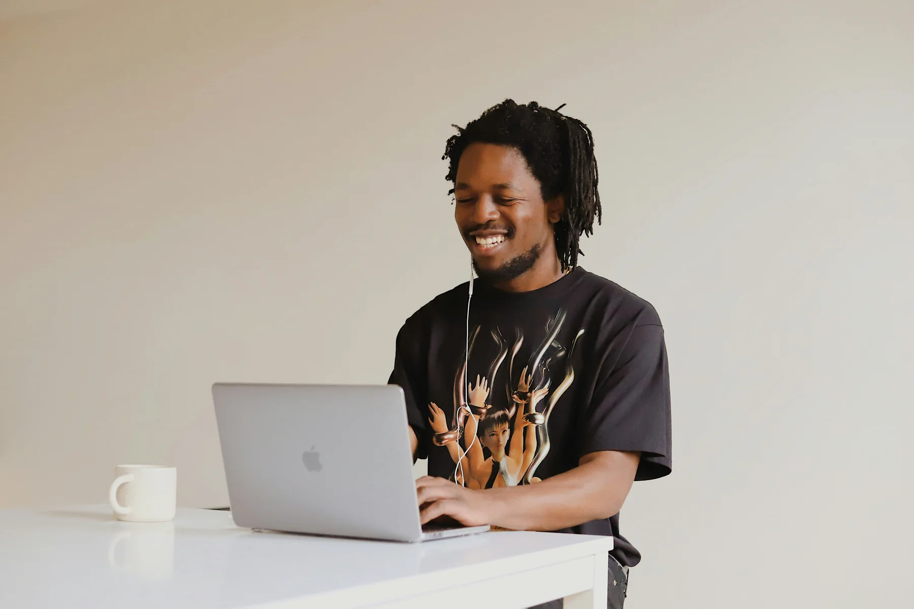 A smiling professional on a video call at a desk